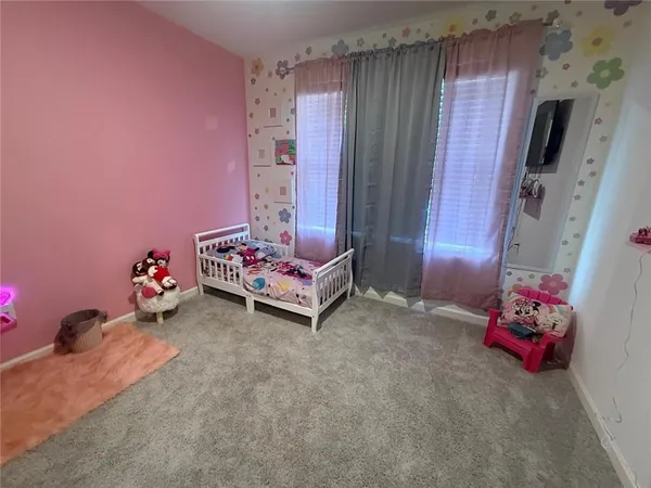 a bedroom with furniture and a tv