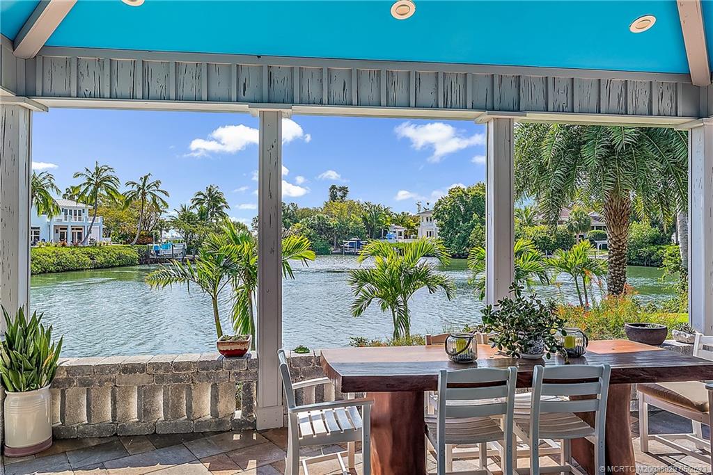 9 Simara Street Stuart, FL 34996 - Photo 10 of 46 a view of a patio with table and chairs potted plants with wooden floor