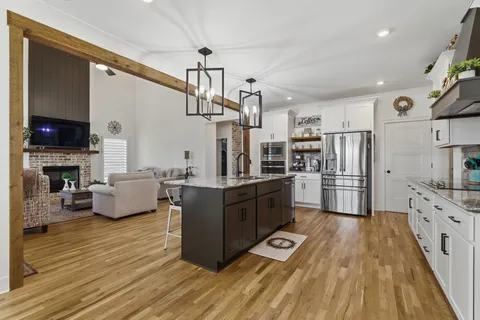 a kitchen with cabinets a sink and a stove