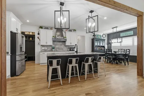 a large kitchen with a table and chairs
