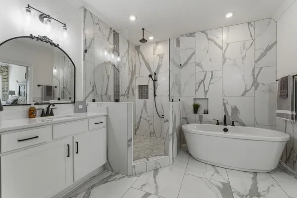a bathroom with a bathtub and shower