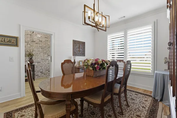 a view of a dining room with furniture and window