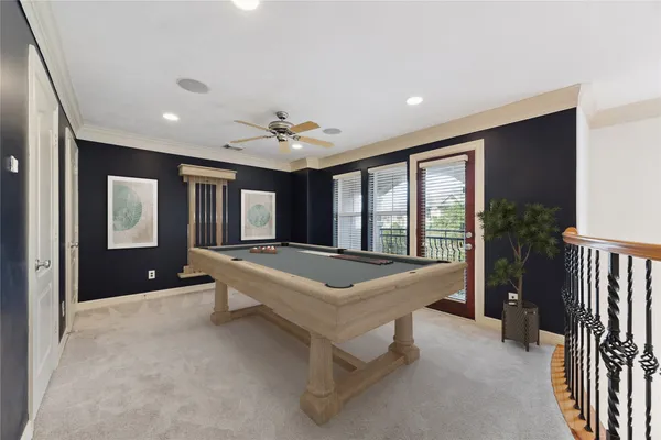 a living room with pool table furniture and a window