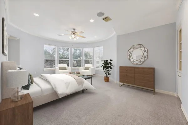 a spacious bedroom with a bed a window and a chandelier