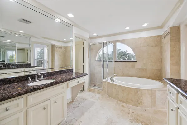 a spacious bathroom with a granite countertop sink a toilet a mirror and bathtub