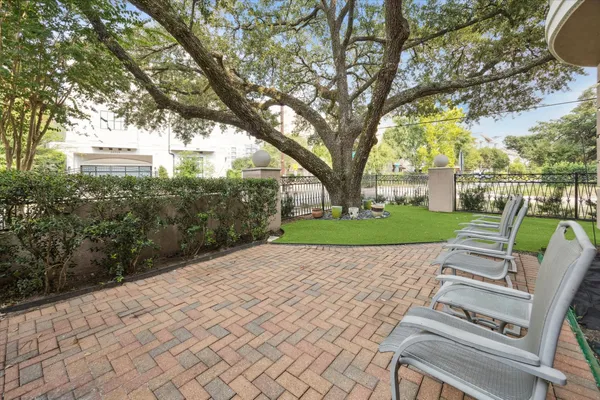 a view of backyard with seating area and trees