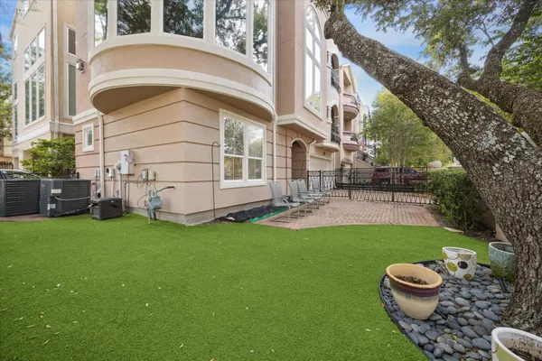 a backyard of a house with table and chairs