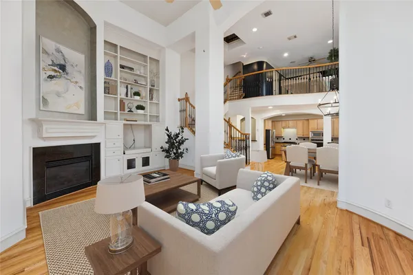 a living room with furniture fireplace and wooden floor
