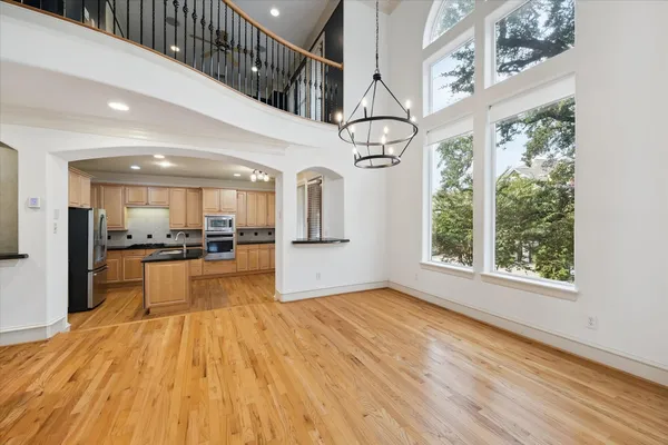 a view of a living room with kitchen view and wooden floor