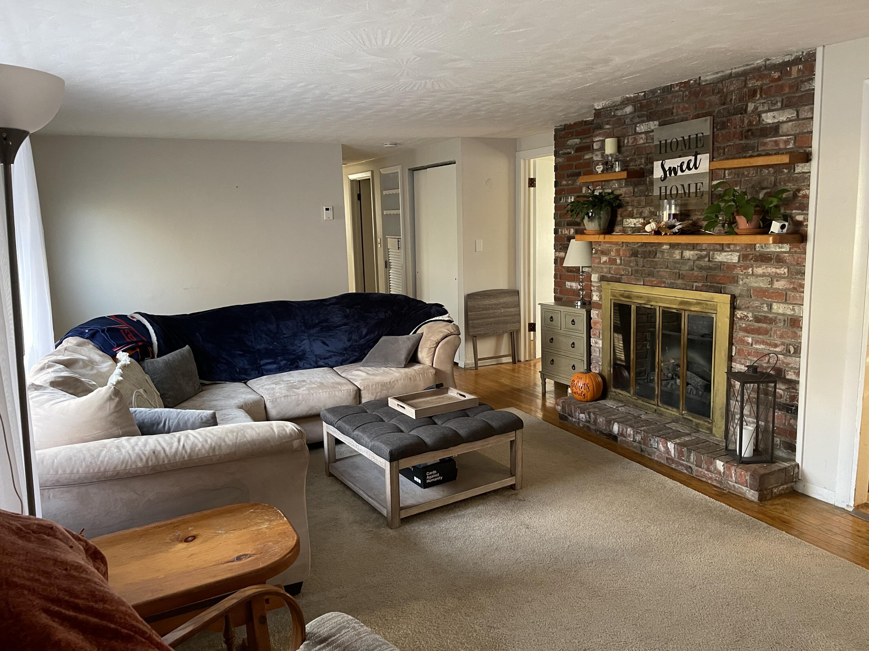 419 Old Stage Road Centerville, MA 02632 - Photo 8 of 19 a living room with furniture and a fireplace