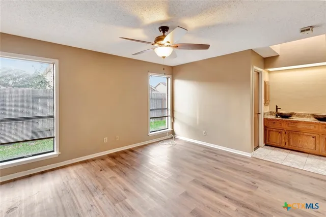 wooden floor in an empty room with a window