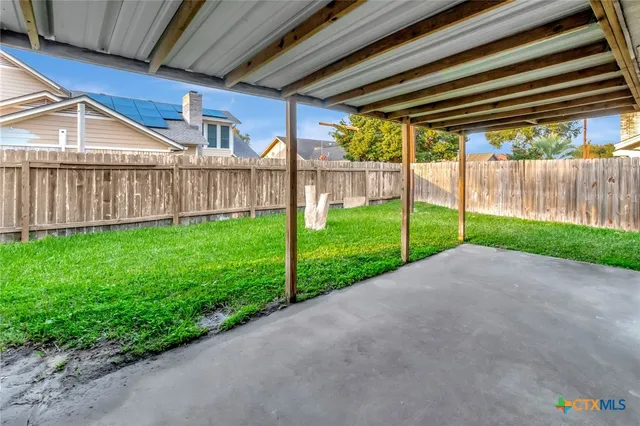 a view of a house with backyard and porch