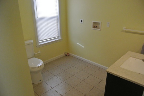 208 Whittenton Street Taunton, MA 02780 - Photo 4 of 15 a bathroom with a sink and a vanity