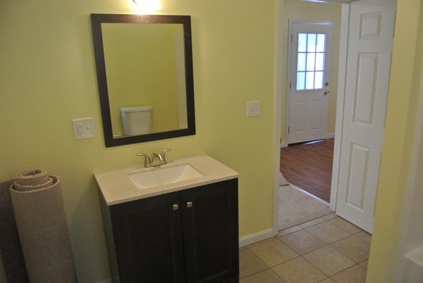 208 Whittenton Street Taunton, MA 02780 - Photo 5 of 15 a bathroom with a sink and a mirror