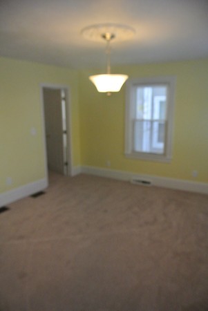 208 Whittenton Street Taunton, MA 02780 - Photo 7 of 15 an empty room with a empty space and a window