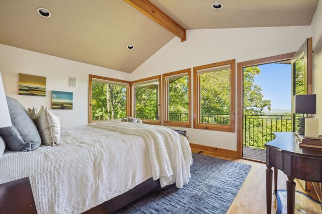 a bed sitting in a bedroom next to a large window