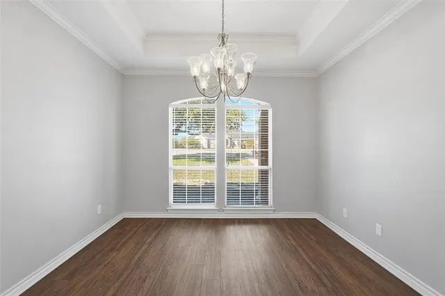 a view of wooden floor and windows in a room