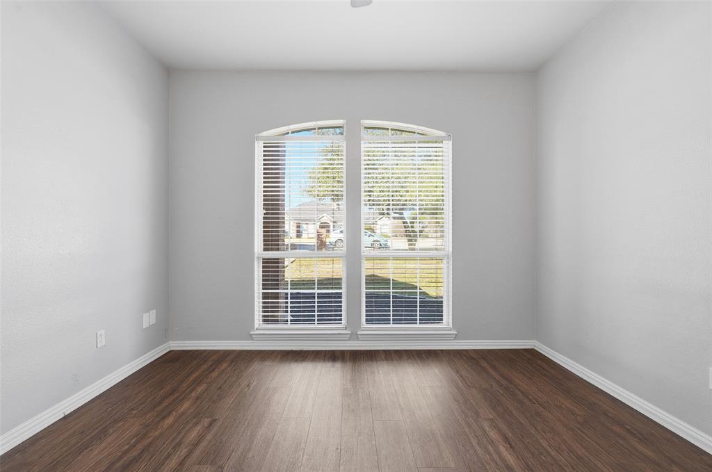 135 Rim Rock Road Aledo, TX 76008 - Photo 20 of 40 an empty room with wooden floor and windows