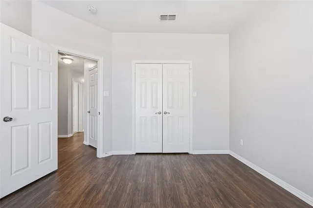 an empty room with wooden floor