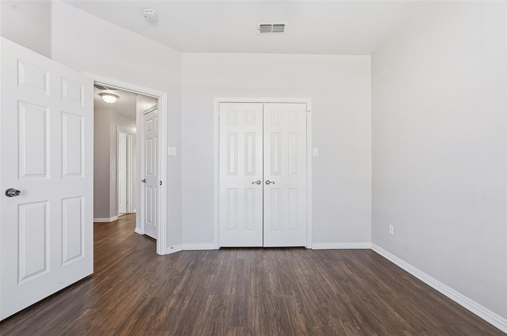 135 Rim Rock Road Aledo, TX 76008 - Photo 21 of 40 an empty room with wooden floor