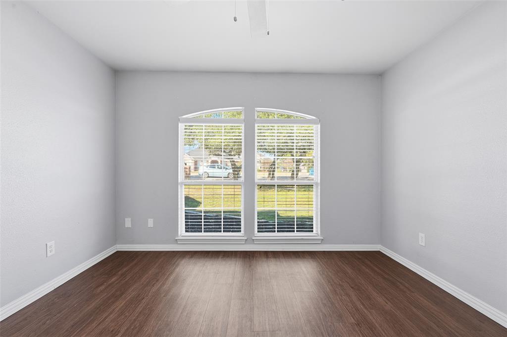 135 Rim Rock Road Aledo, TX 76008 - Photo 22 of 40 an empty room with wooden floor and windows