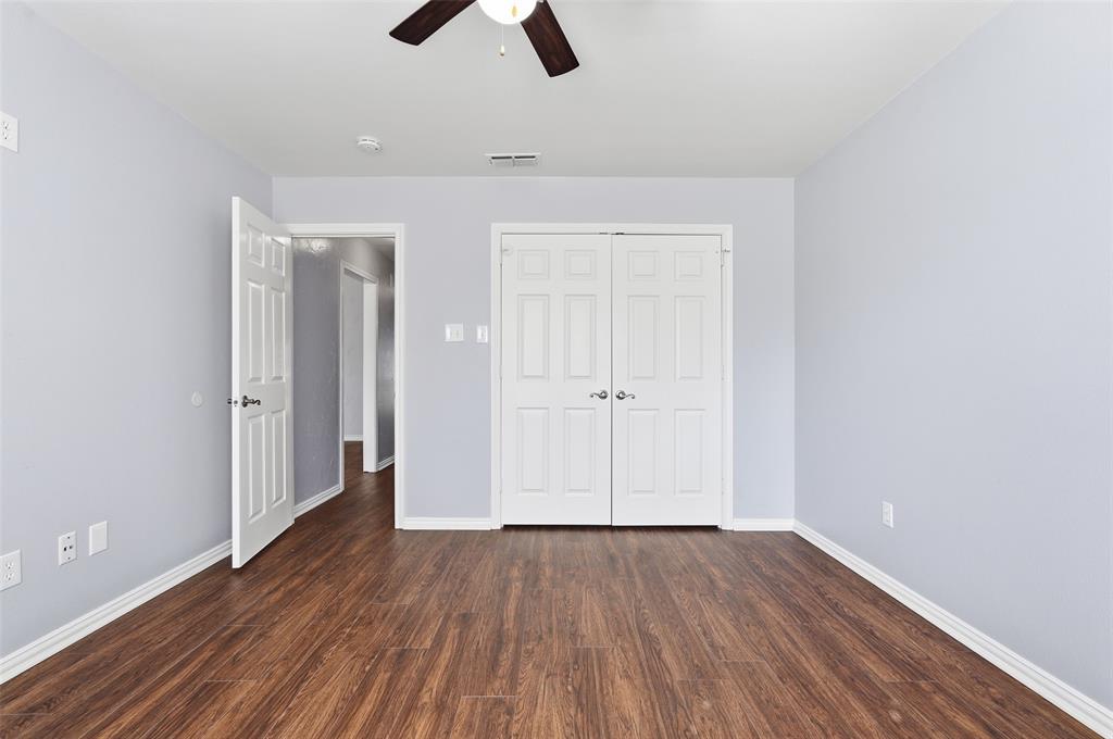 135 Rim Rock Road Aledo, TX 76008 - Photo 25 of 40 an empty room with wooden floor cabinet and windows