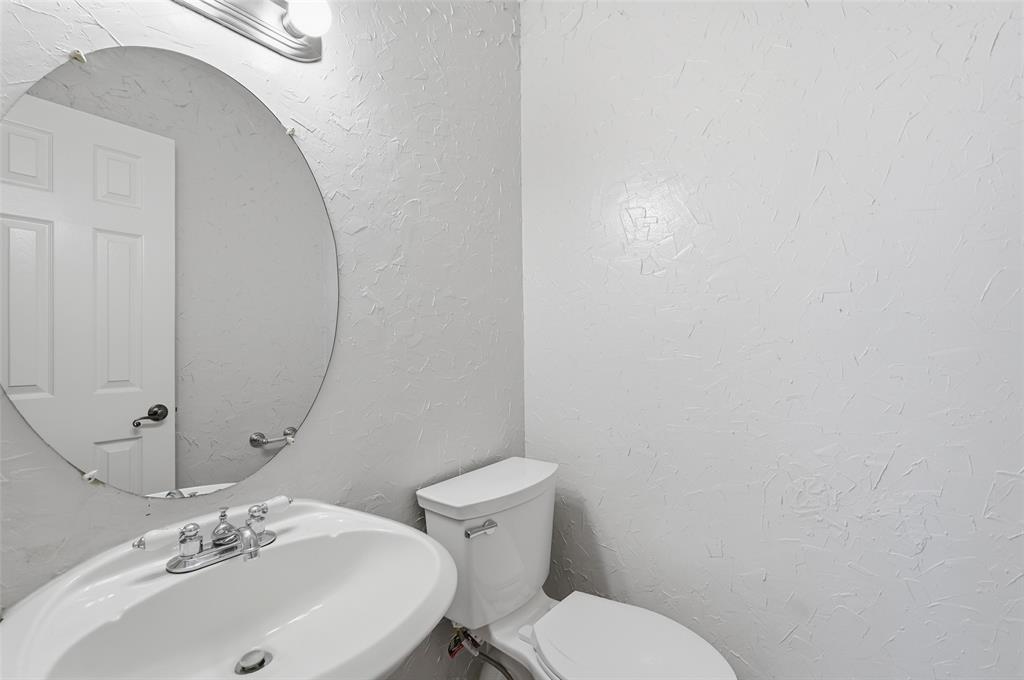 135 Rim Rock Road Aledo, TX 76008 - Photo 32 of 40 a bathroom with a sink mirror and toilet