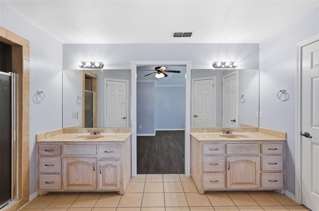 135 Rim Rock Road Aledo, TX 76008 - Photo 33 of 40 a spacious bathroom with a double vanity sink a mirror a bathtub and shower