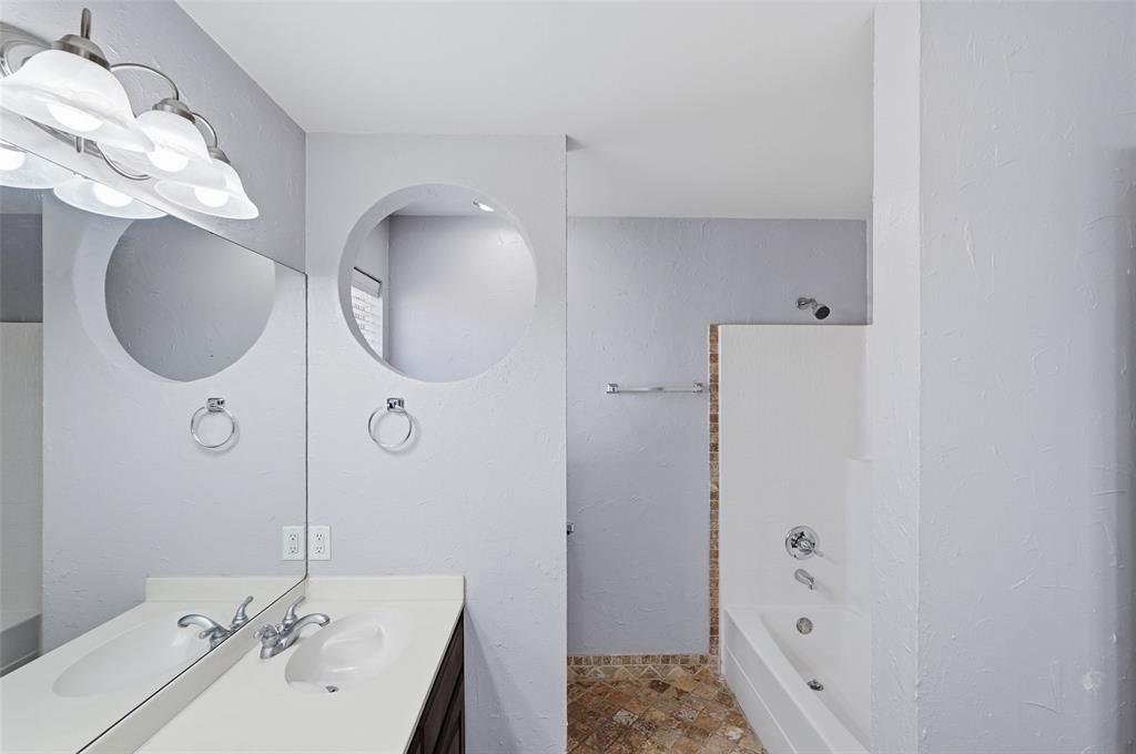 135 Rim Rock Road Aledo, TX 76008 - Photo 35 of 40 a bathroom with a sink a mirror and a shower