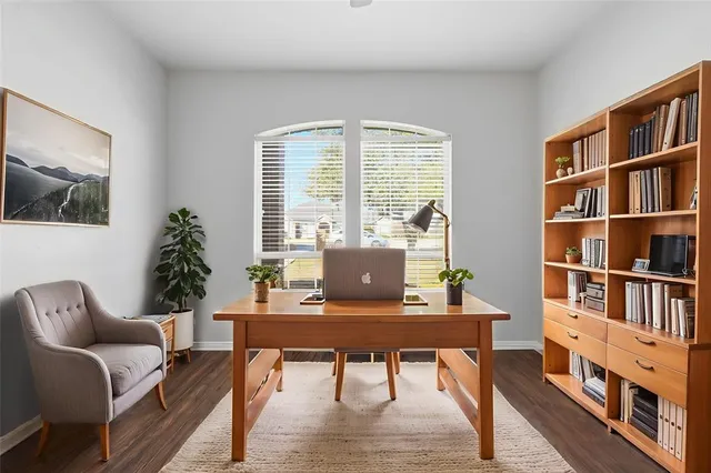 a workspace with furniture window and wooden floor