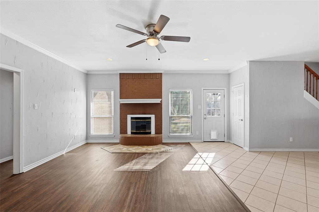 135 Rim Rock Road Aledo, TX 76008 - Photo 7 of 40 a view of livingroom with hardwood floor and a ceiling fan