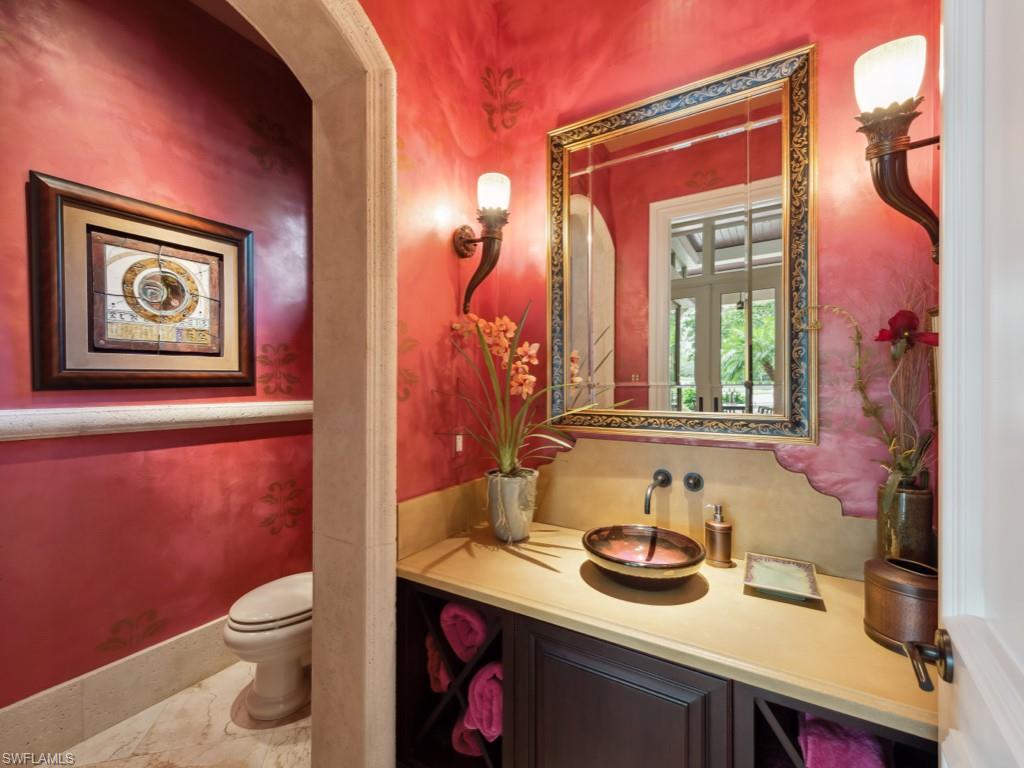 17012 Treviso Way Naples, FL 34110 - Photo 13 of 50 a bathroom with a toilet a sink and a mirror