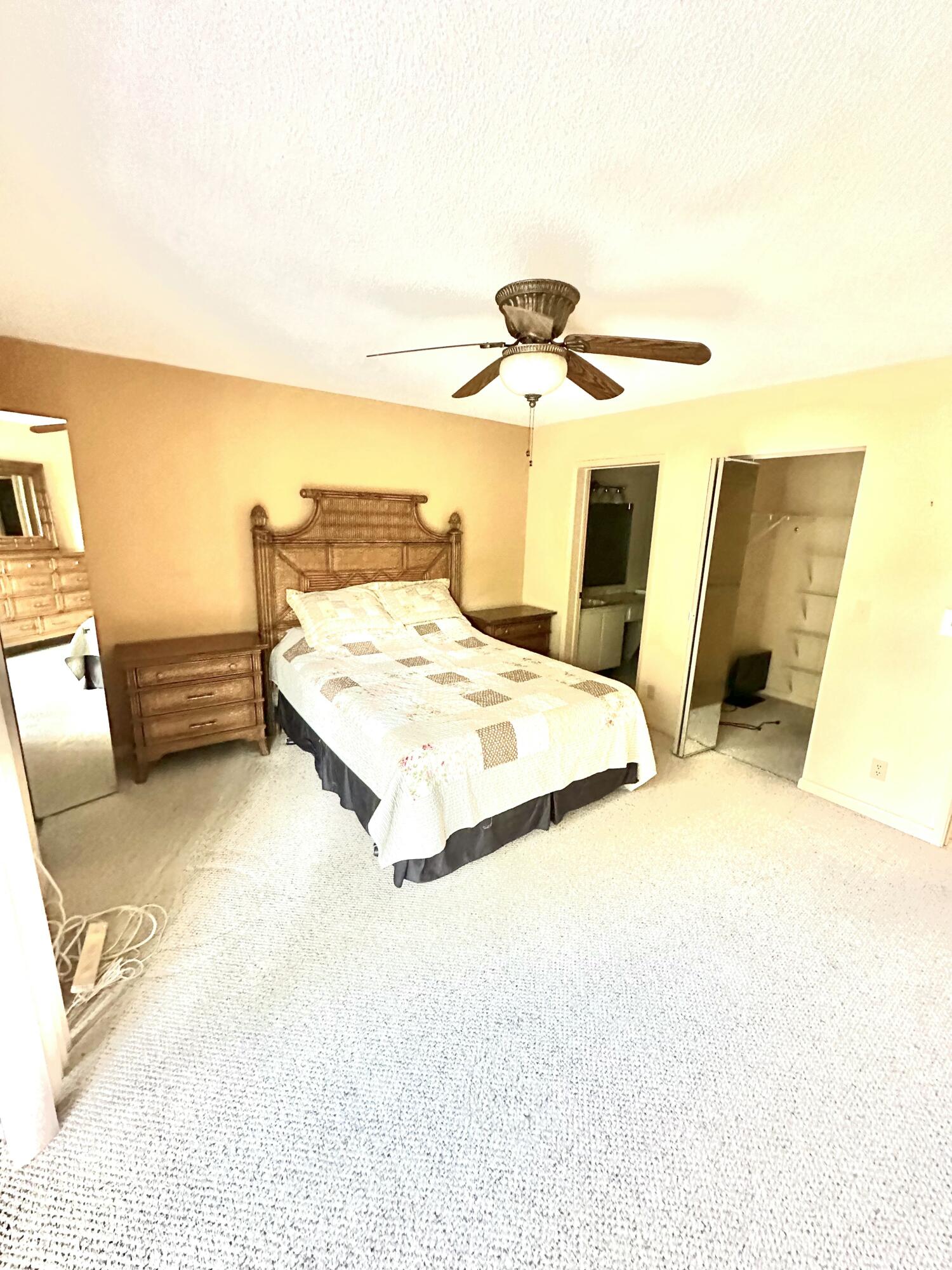 7281 Amberly Lane, Unit 308 Delray Beach, FL 33446 - Photo 5 of 20 a bedroom with a bed and a view of kitchen