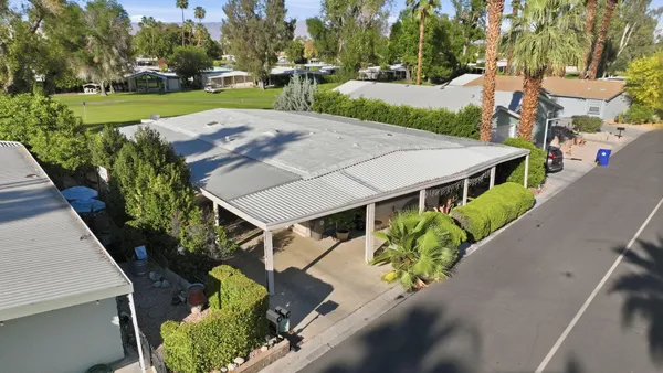 an aerial view of a house with garden space and street view