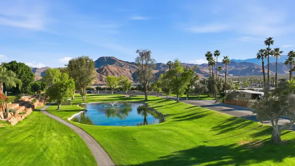 a view of a swimming pool with a yard