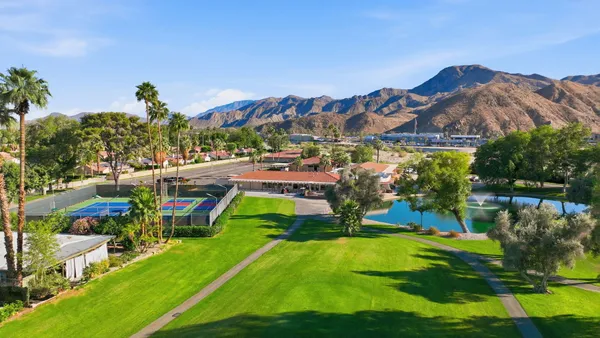 a view of an houses with swimming pool and a yard