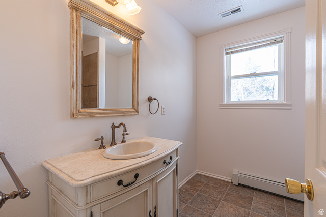 1045 Fox Farm Road Logan, UT 84321 - Photo 43 of 65 Bathroom with baseboard heating and vanity