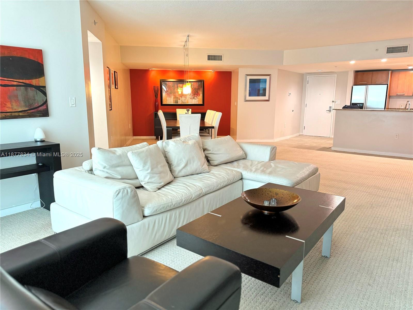 9055 Southwest 73rd Court, Unit 1705 Miami, FL 33156 - Photo 2 of 16 a living room with furniture and a wooden floor
