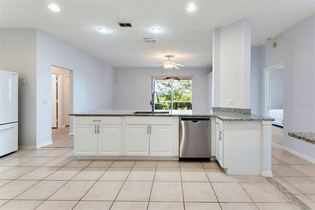 3984 Beacon Ridge Way Clermont, FL 34711 - Photo 14 of 59 Kitchen with view of Family Room and Back Patio