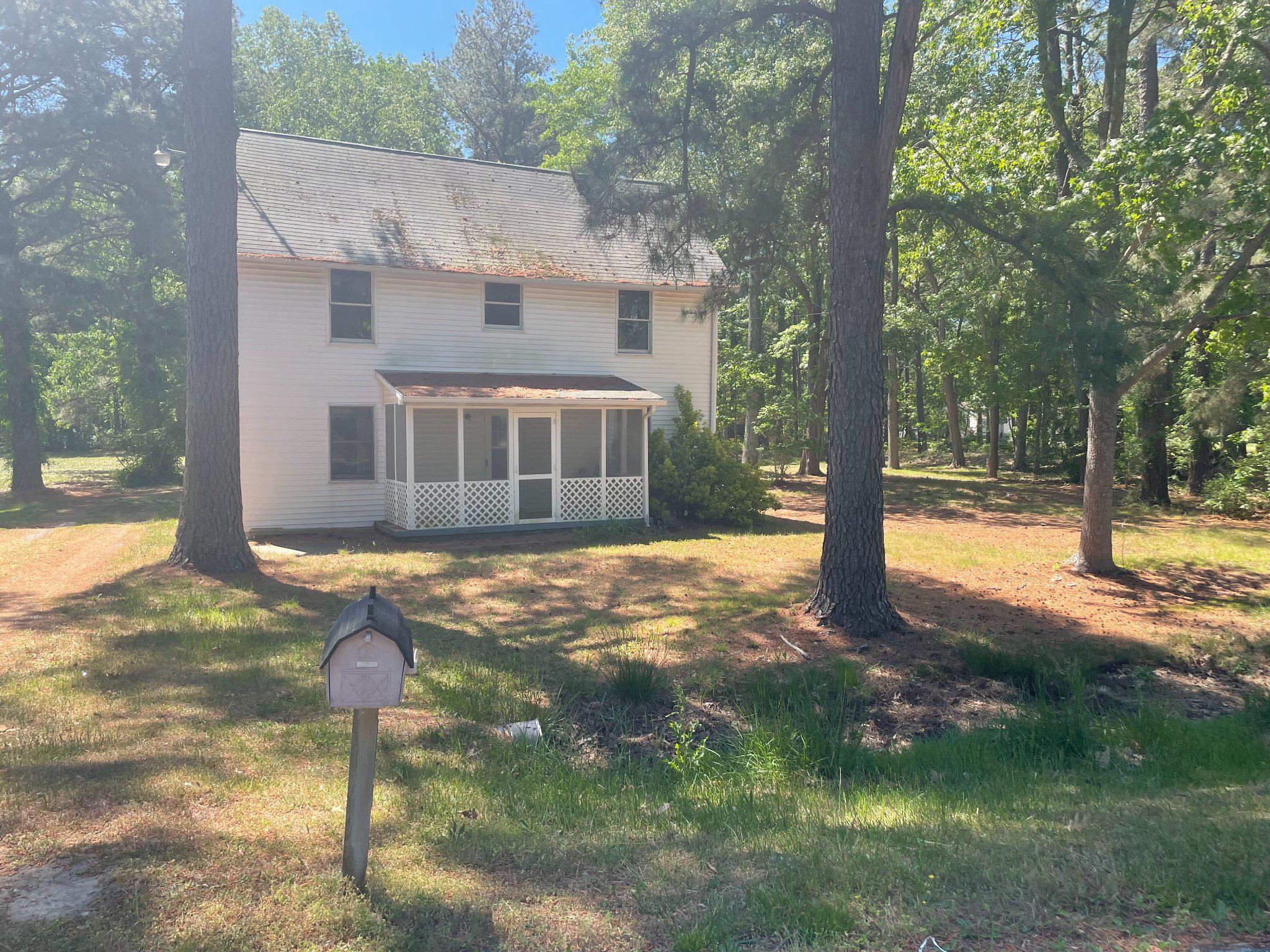 a view of a house with backyard and tree