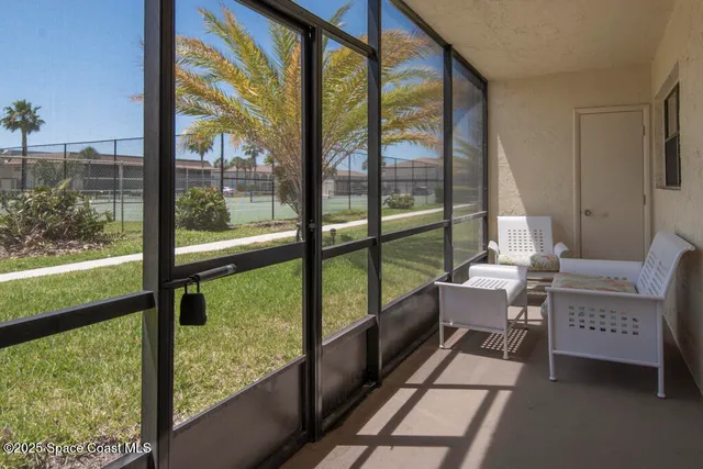 a room with a large window and sitting area