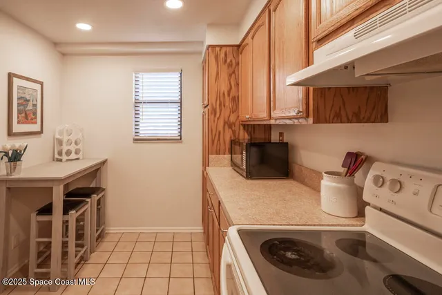 a kitchen with a stove a sink and a refrigerator