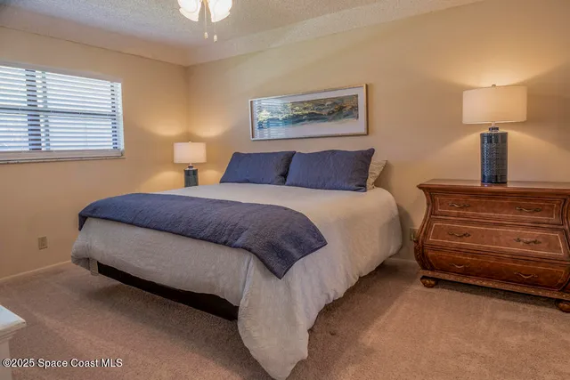 a bedroom with a bed and a lamp