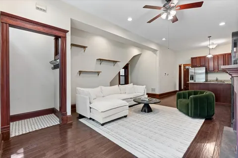 a living room with furniture and a wooden floor