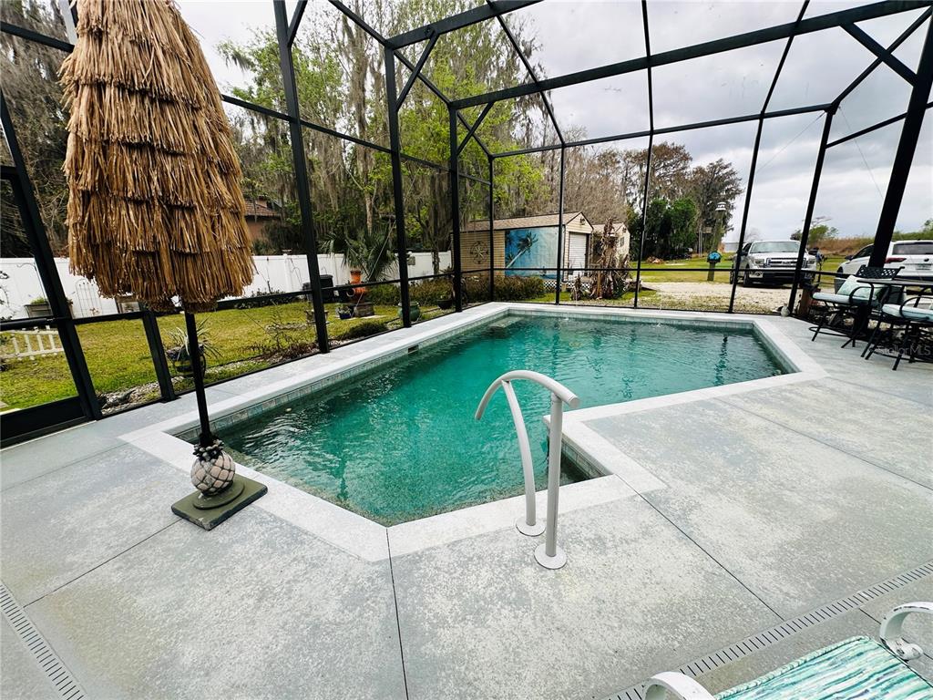 357 Magnolia Place DeBary, FL 32713 - Photo 12 of 50 a view of a swimming pool with a porch