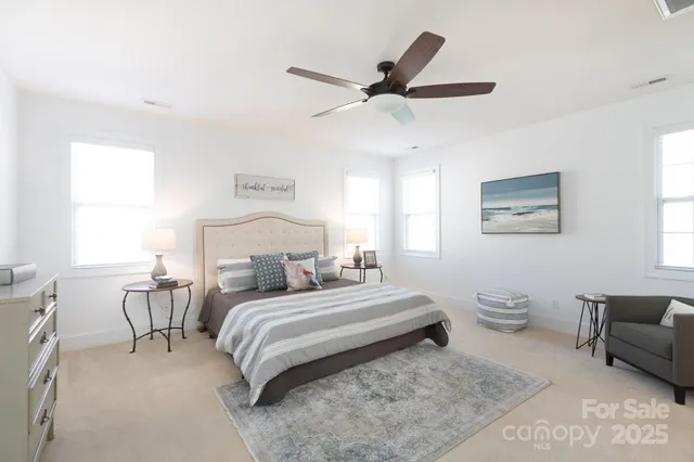 a bedroom with a bed a couch and a window