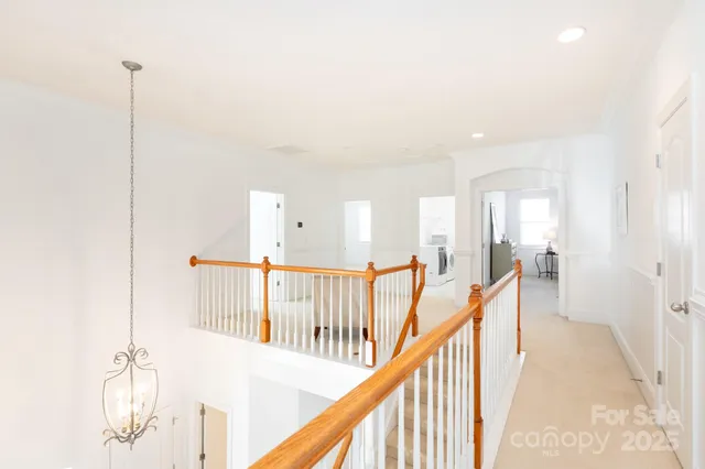 a view of a hallway with a large window and wooden floor