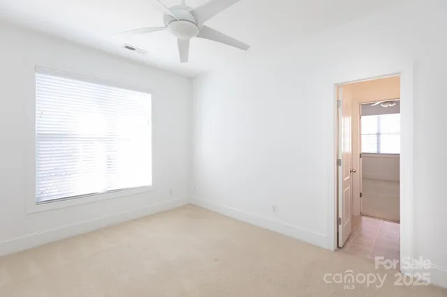 an empty room with a window and a bathroom