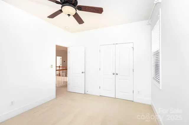 a view of a room with a ceiling fan