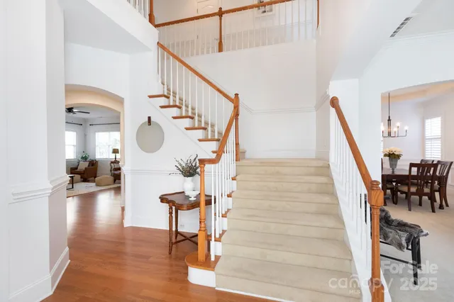 a view of entryway and hall with wooden floor